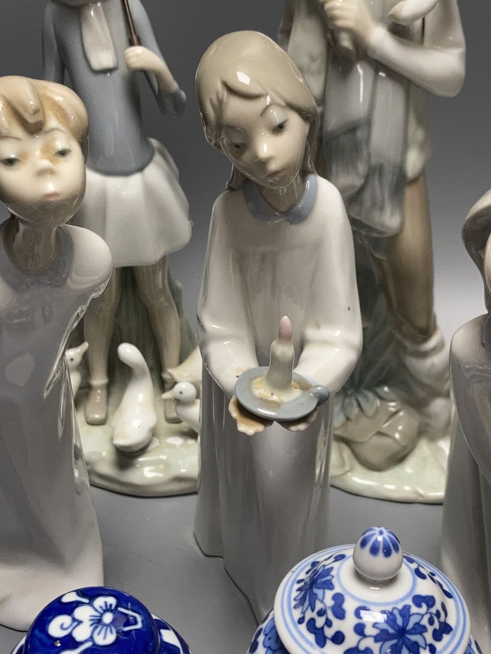 A collection of Lladro and Goebel porcelain figures and other items